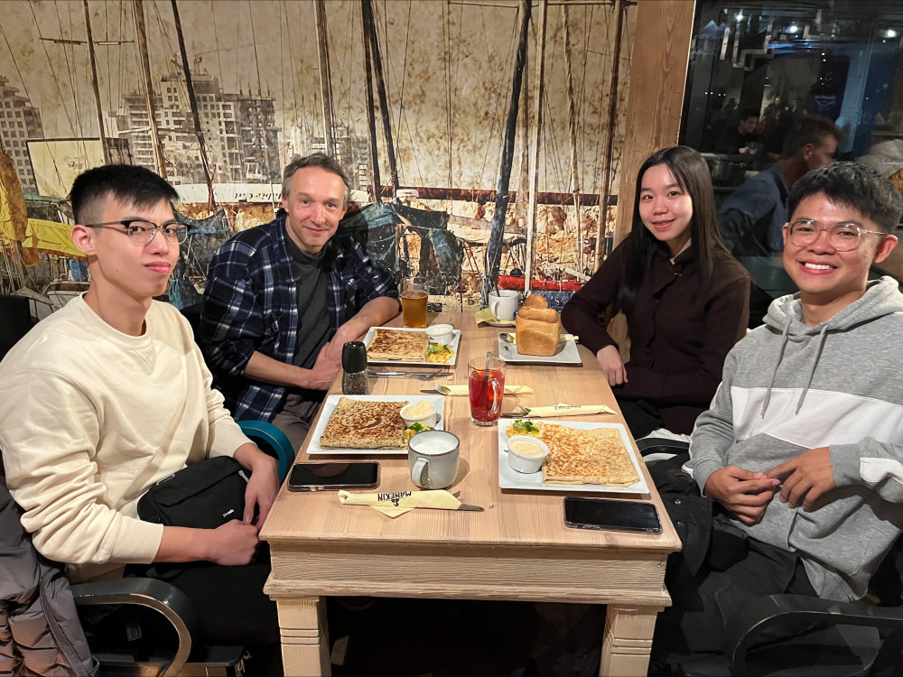 four people sitting at a table