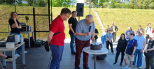 Deans on the stage with thematical cake