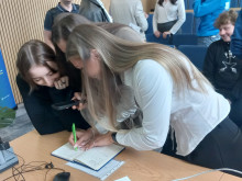 students signing the Q-Camp journal